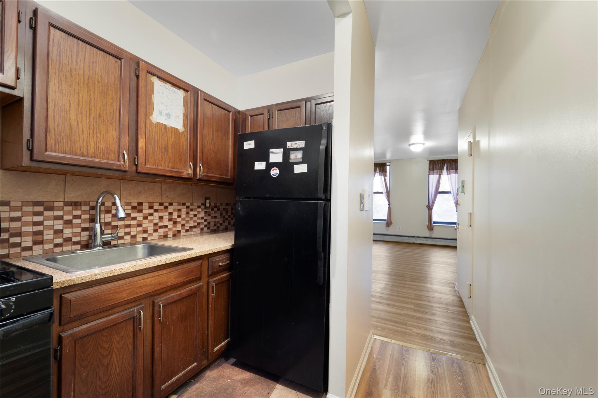 369 Marion Street, Unit 2B Brooklyn, NY 11233 - Photo 7 of 9 a kitchen with a sink and refrigerator