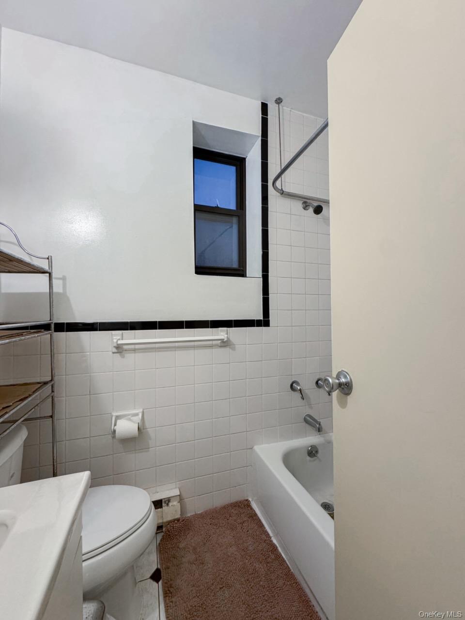 369 Marion Street, Unit 2B Brooklyn, NY 11233 - Photo 9 of 9 a bathroom with a sink a toilet and shower