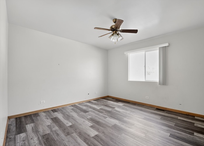 602 Merrill Avenue Calumet City, IL 60409 - Photo 11 of 22 a view of empty room with wooden floor and fan