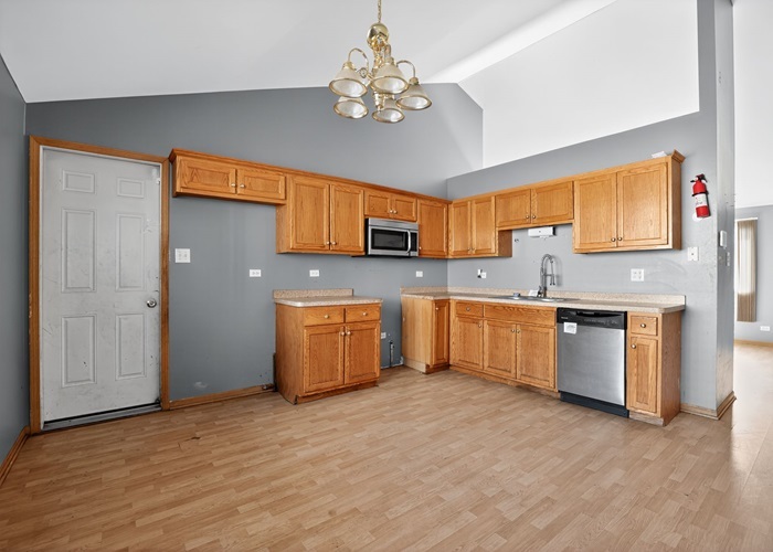 602 Merrill Avenue Calumet City, IL 60409 - Photo 17 of 22 a kitchen with a sink cabinets and window