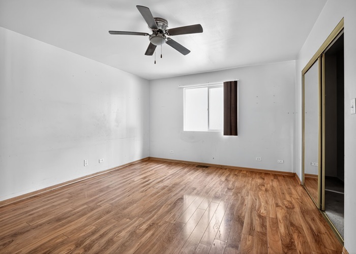 602 Merrill Avenue Calumet City, IL 60409 - Photo 18 of 22 an empty room with wooden floor and windows