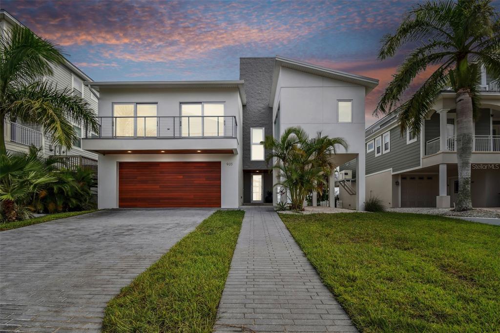 a front view of a house with a garden and yard