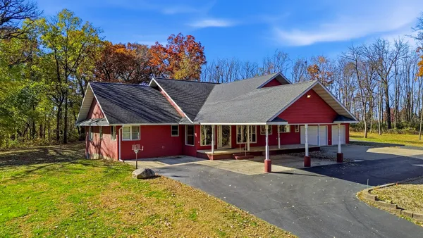 a view of a house with a yard porch and furniture