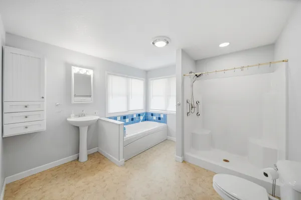 a bathroom with a sink toilet and shower