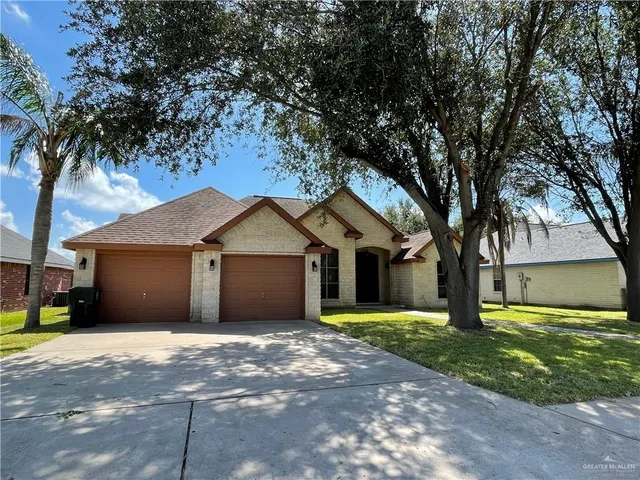 a front view of house with yard and trees
