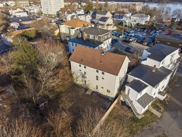 an aerial view of a house with a yard