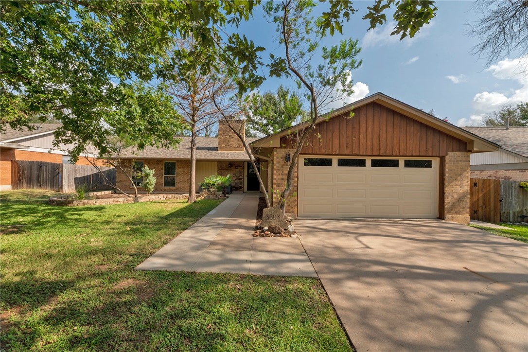 5508 Wagon Train Road Austin, TX 78749 - Photo 1 of 1 a front view of a house with a yard and trees