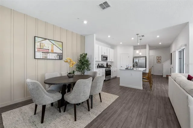 a view of a dining room with furniture and wooden floor