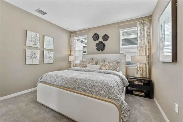 a bedroom with a large bed and a window