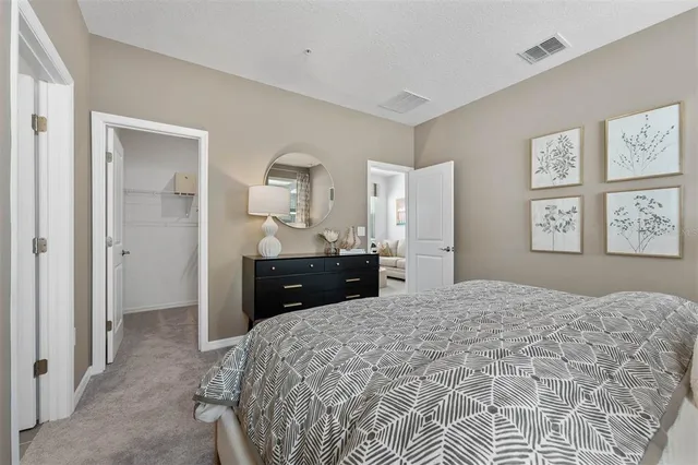 a bedroom with a bed and a dresser