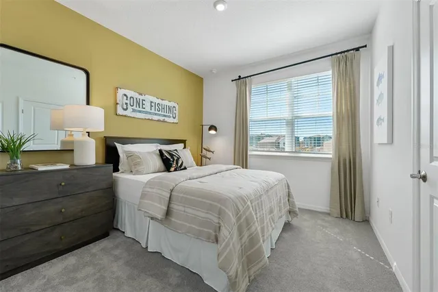 a bedroom with a bed and a night stand