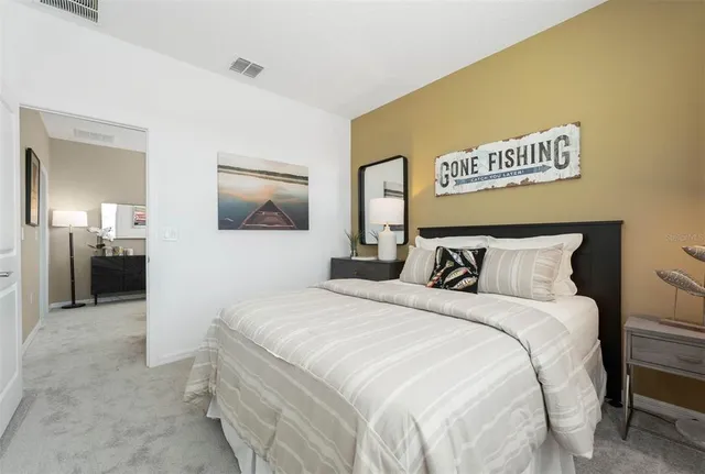 a bedroom with a bed and a painting