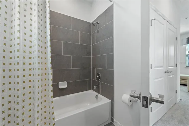 a bathroom with a bathtub and a shower