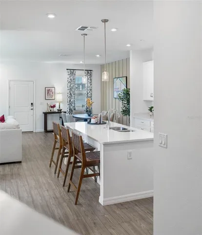 a view of a dining room with furniture and wooden floor
