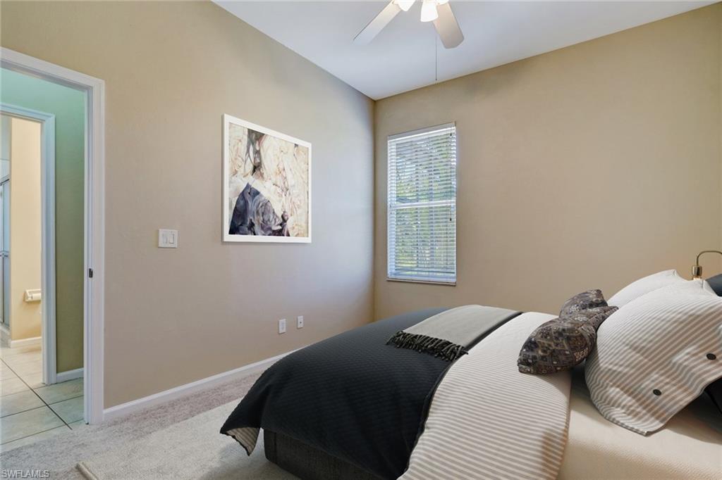 6564 Chestnut Circle Naples, FL 34109 - Photo 16 of 27 a bedroom with a bed and a window