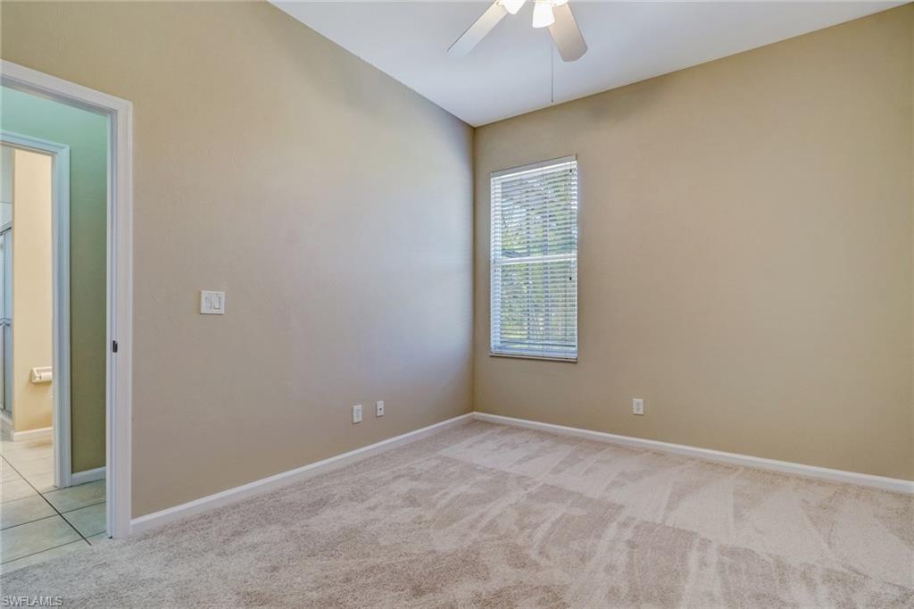 6564 Chestnut Circle Naples, FL 34109 - Photo 17 of 27 an empty room with windows and closet
