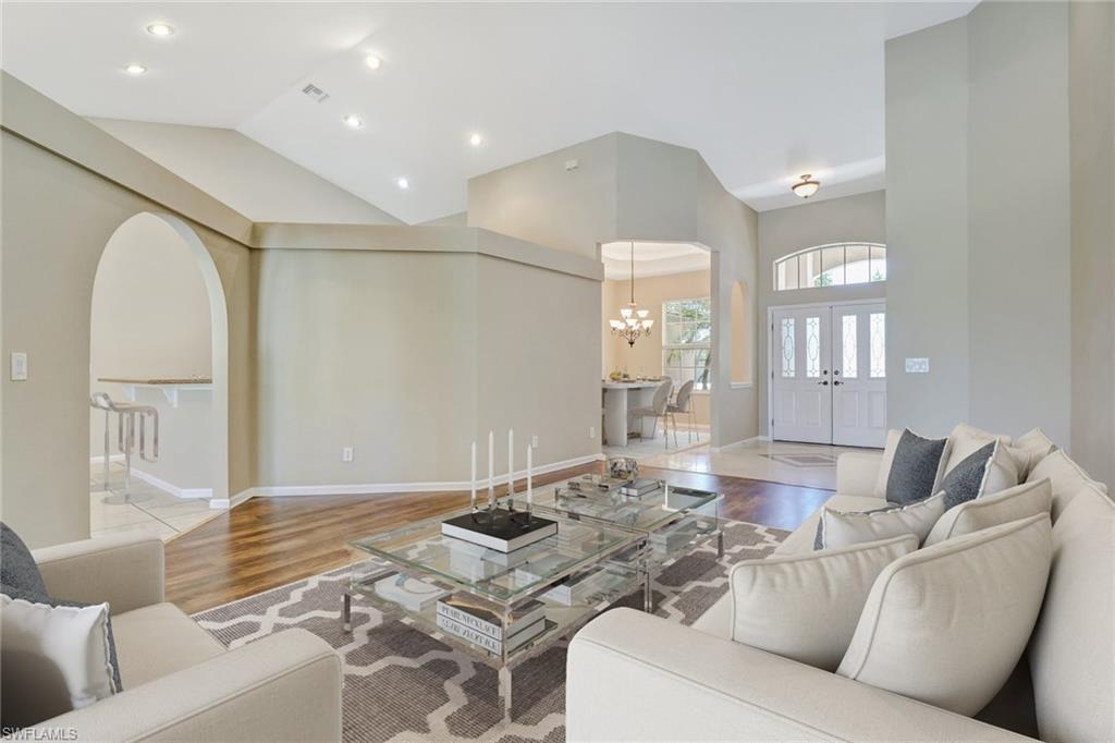 6564 Chestnut Circle Naples, FL 34109 - Photo 2 of 27 a living room with furniture and wooden floor