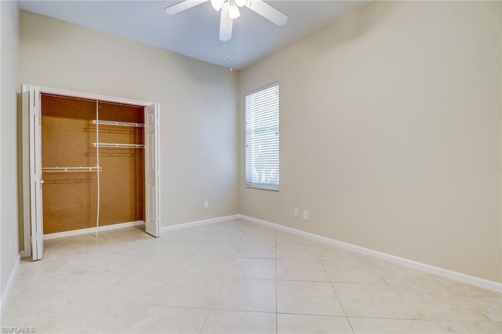6564 Chestnut Circle Naples, FL 34109 - Photo 21 of 27 an empty room with chandelier fan
