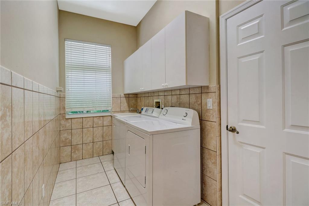6564 Chestnut Circle Naples, FL 34109 - Photo 23 of 27 a utility room with dryer and washer