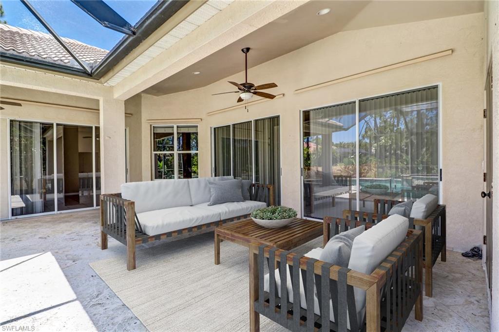 6564 Chestnut Circle Naples, FL 34109 - Photo 24 of 27 a living room with furniture and a window