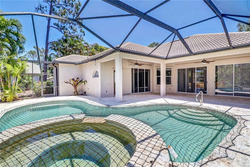 6564 Chestnut Circle Naples, FL 34109 - Photo 27 of 27 a swimming pool with patio outdoor seating and yard