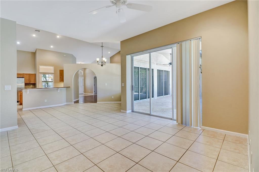 6564 Chestnut Circle Naples, FL 34109 - Photo 5 of 27 a view of a hallway with wooden cabinets and glass door