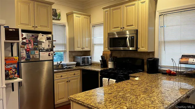 a kitchen with a refrigerator and a stove top oven