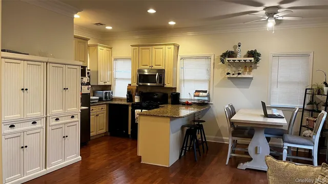 a kitchen with cabinets and wooden floor