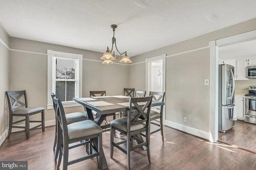 4090 Old Town Road Huntingtown, MD 20639 - Photo 6 of 20 a view of a dining room with furniture a chandelier and wooden floor