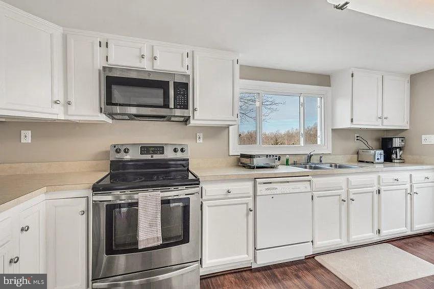 4090 Old Town Road Huntingtown, MD 20639 - Photo 7 of 20 a kitchen with white cabinets and appliances