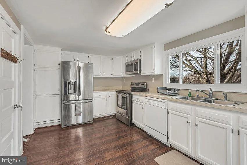 4090 Old Town Road Huntingtown, MD 20639 - Photo 8 of 20 a kitchen with white cabinets and white appliances
