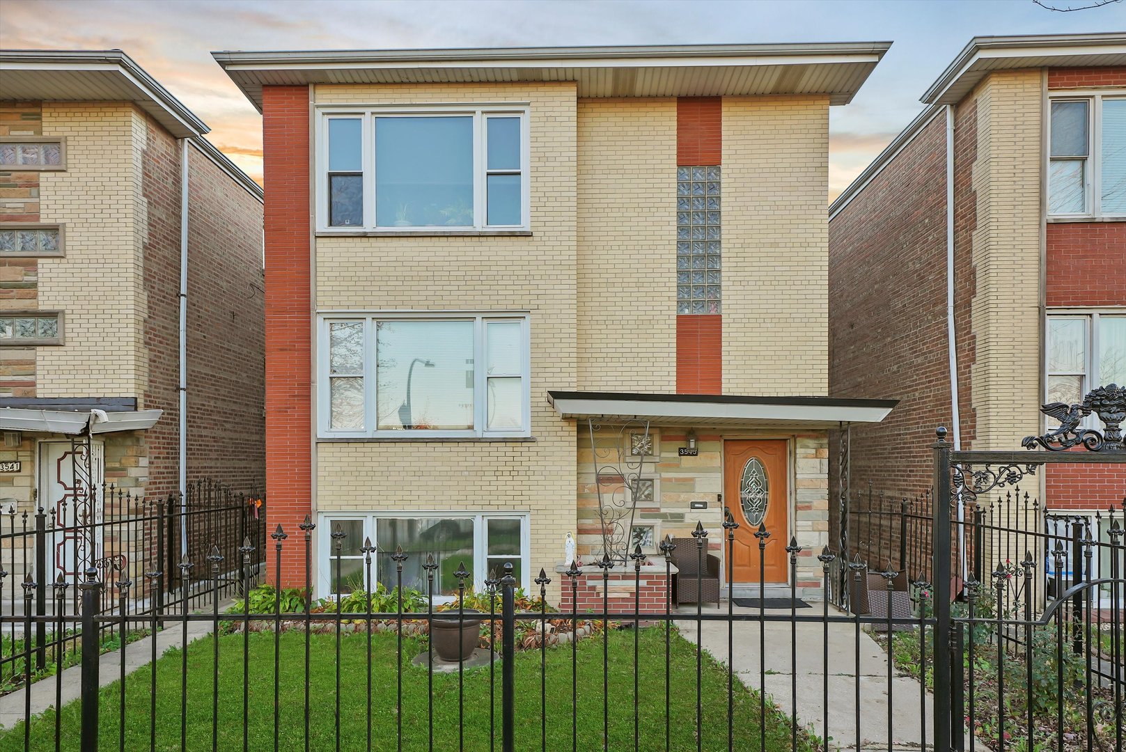 3543 West 57th Street Chicago, IL 60629 - Photo 1 of 43 a view of a brick house with many windows