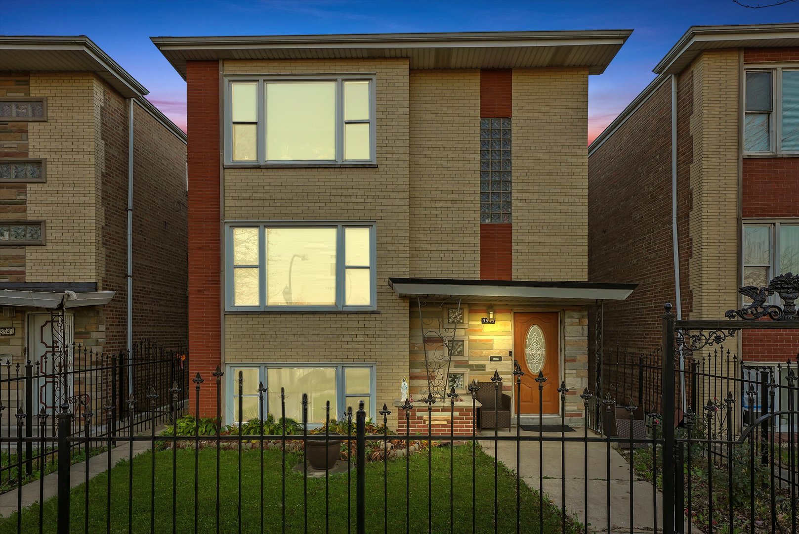 3543 West 57th Street Chicago, IL 60629 - Photo 2 of 43 a front view of a house with a glass door