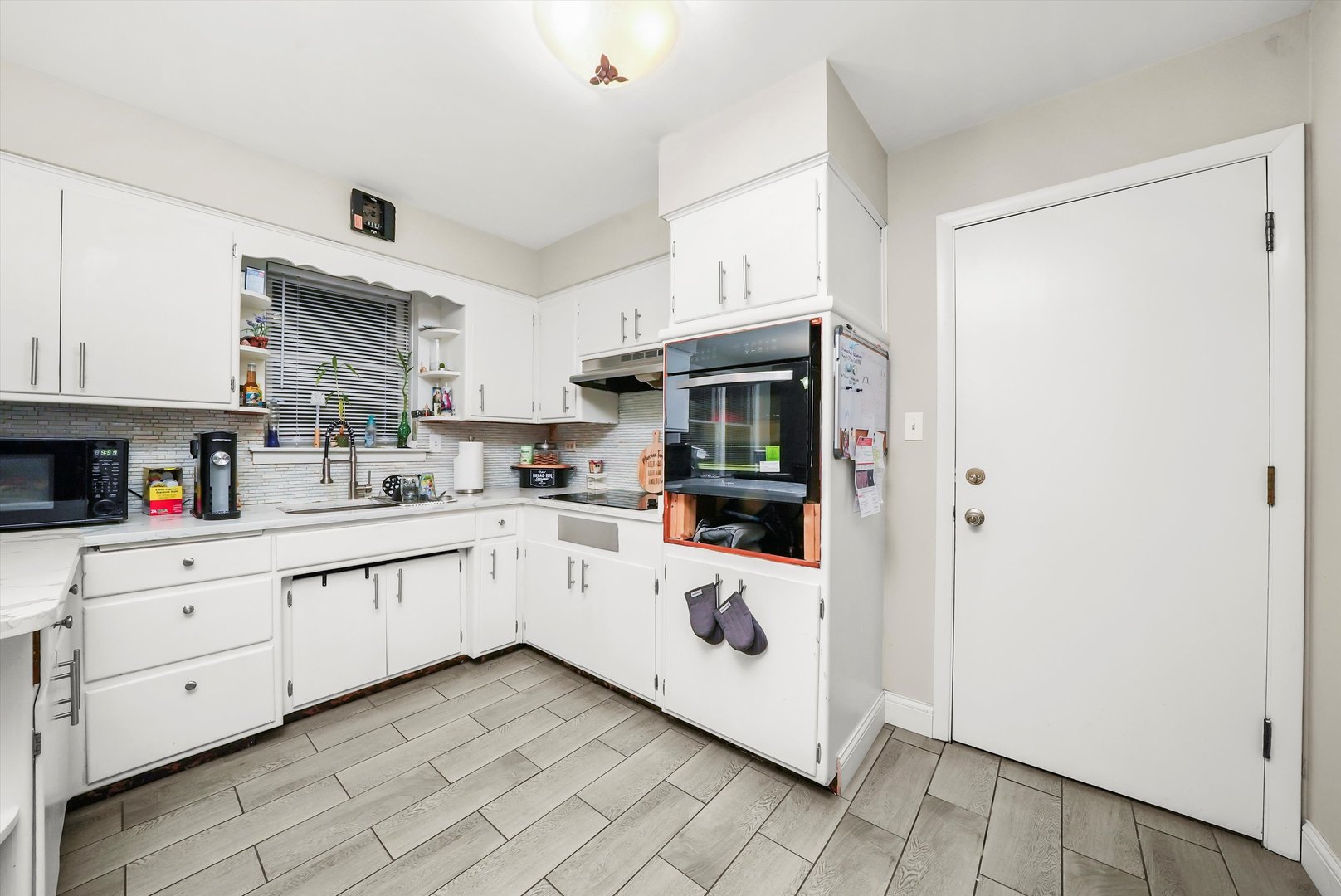 3543 West 57th Street Chicago, IL 60629 - Photo 21 of 43 a kitchen with white cabinets and white appliances
