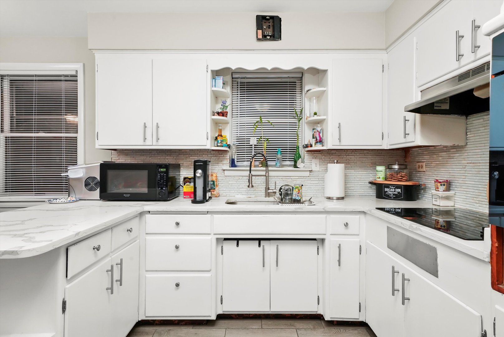 3543 West 57th Street Chicago, IL 60629 - Photo 22 of 43 a kitchen with white cabinets and a stove