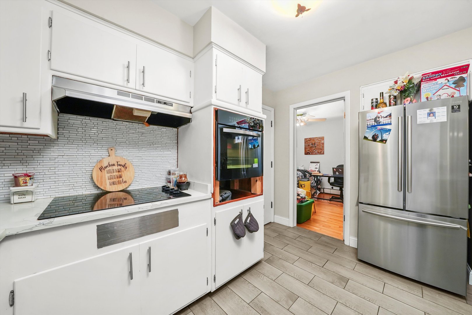 3543 West 57th Street Chicago, IL 60629 - Photo 25 of 43 a kitchen with stainless steel appliances a refrigerator a stove and white cabinets