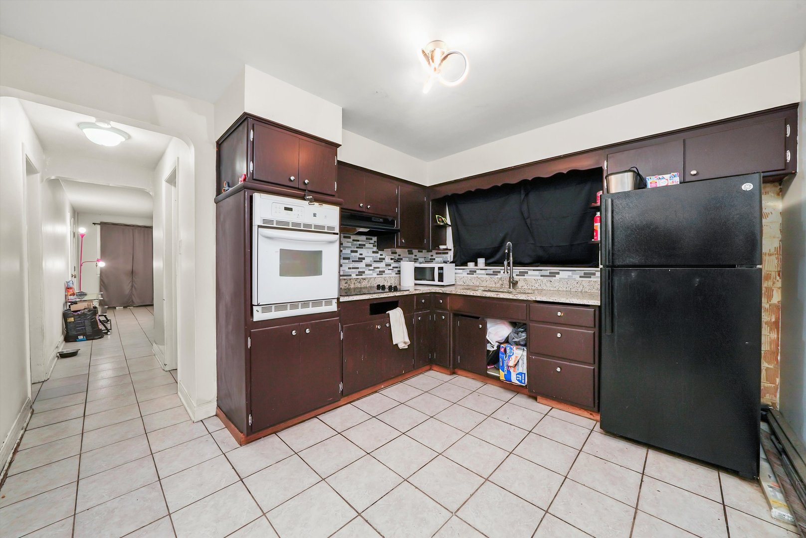 3543 West 57th Street Chicago, IL 60629 - Photo 33 of 43 a kitchen with stainless steel appliances kitchen island granite countertop a refrigerator and a stove top oven