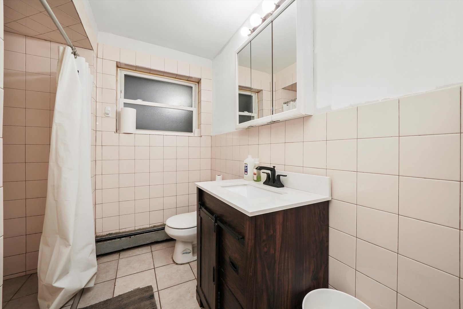 3543 West 57th Street Chicago, IL 60629 - Photo 36 of 43 a bathroom with a sink a toilet and mirror