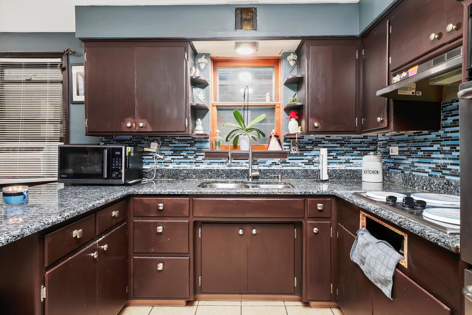 3543 West 57th Street Chicago, IL 60629 - Photo 10 of 43 a kitchen with stainless steel appliances granite countertop a sink stove and cabinets