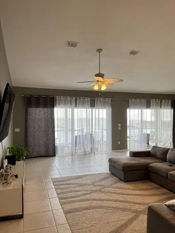a living room with furniture and a chandelier