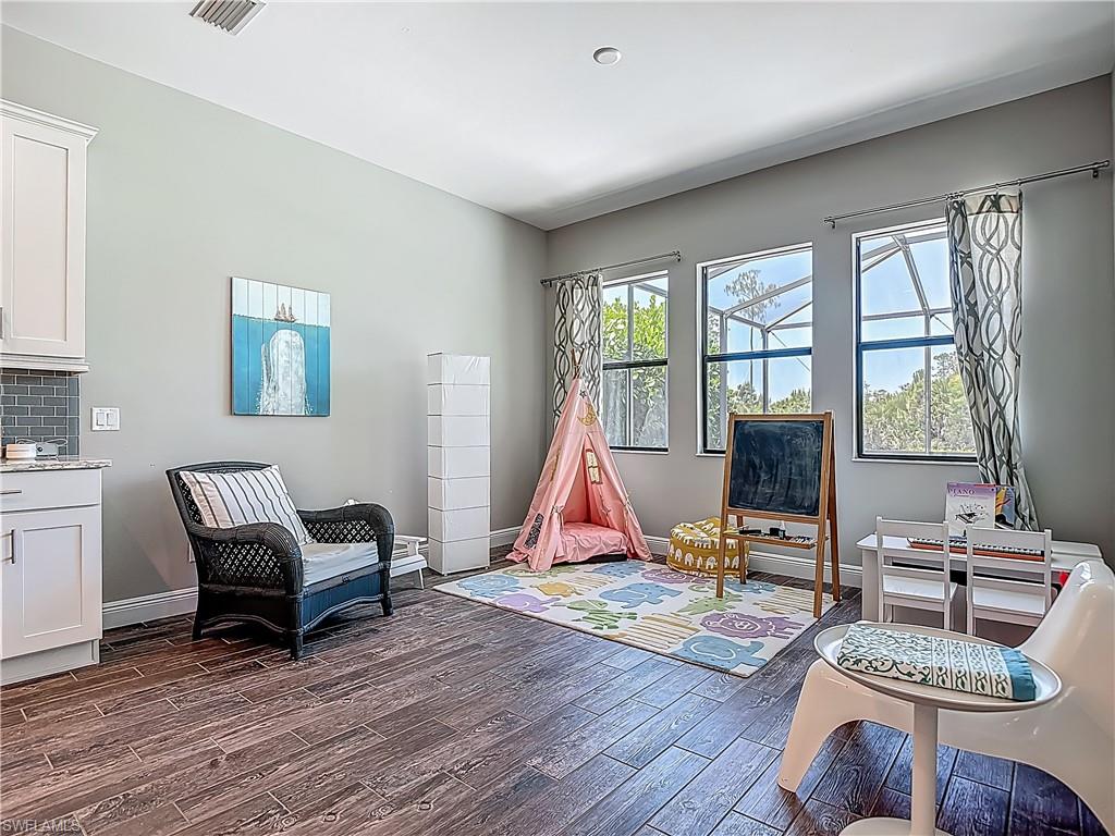 4524 Tamarind Way Naples, FL 34119 - Photo 15 of 50 Rec room with dark wood-style floors and baseboards