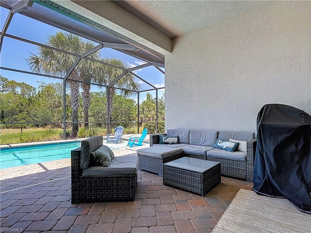 4524 Tamarind Way Naples, FL 34119 - Photo 36 of 50 View of patio / terrace with an outdoor living space, an outdoor pool, and glass enclosure