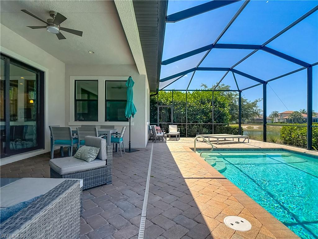 4524 Tamarind Way Naples, FL 34119 - Photo 37 of 50 Outdoor pool featuring a patio, ceiling fan, and glass enclosure