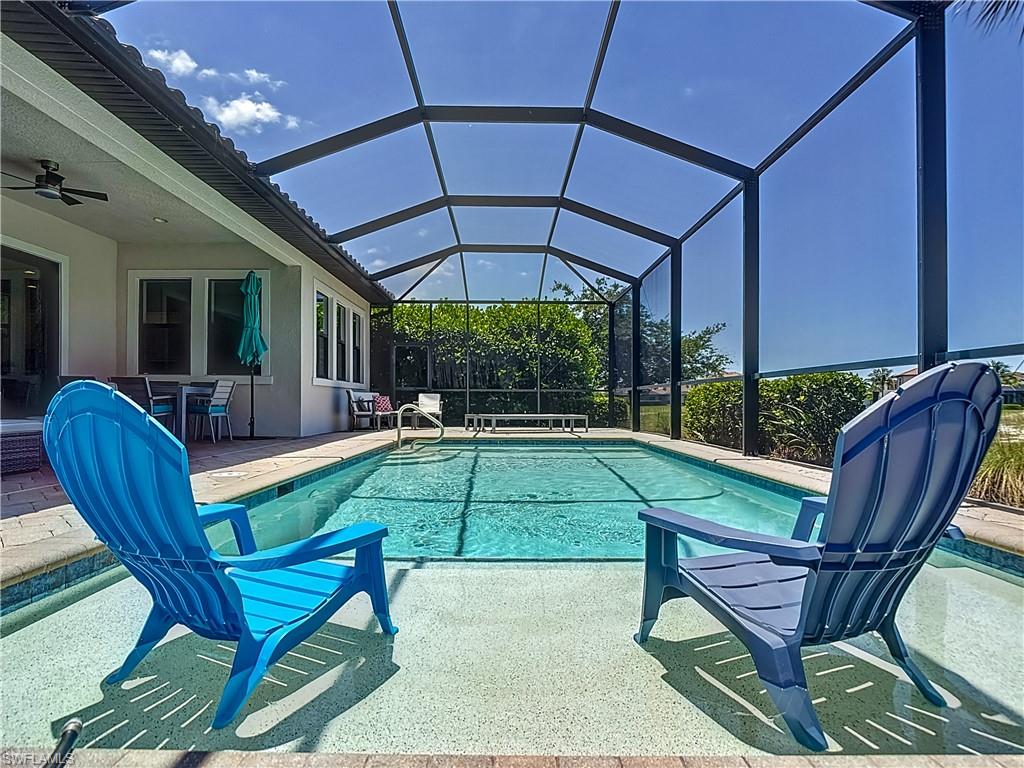 4524 Tamarind Way Naples, FL 34119 - Photo 40 of 50 Outdoor pool featuring a patio, a ceiling fan, a lanai, and a water slide