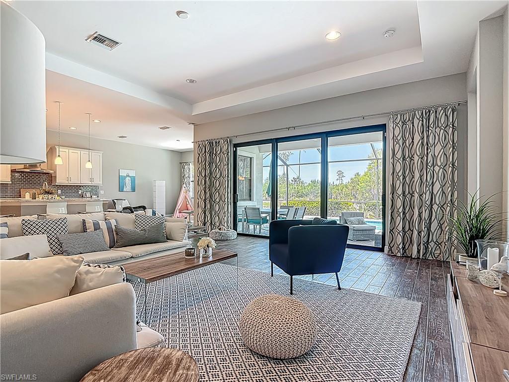 4524 Tamarind Way Naples, FL 34119 - Photo 6 of 50 Living room with hardwood / wood-style flooring, recessed lighting, and a tray ceiling