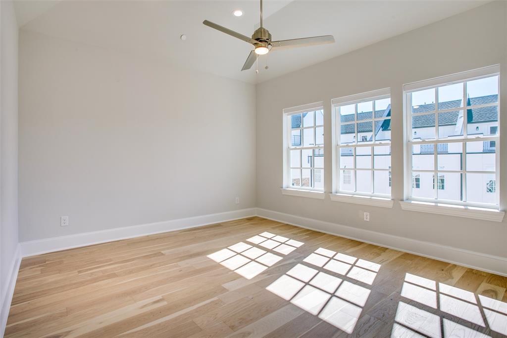 4639 New Water Lane Dallas, TX 75219 - Photo 8 of 20 an empty room with wooden floor and windows