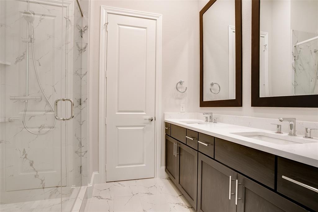 4639 New Water Lane Dallas, TX 75219 - Photo 9 of 20 a bathroom with a double vanity sink a mirror and shower