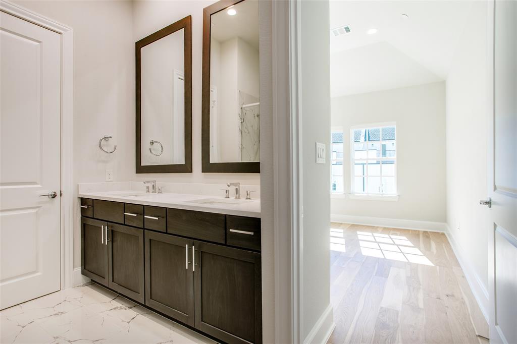 4639 New Water Lane Dallas, TX 75219 - Photo 10 of 20 a bathroom with a sink a mirror and a shower