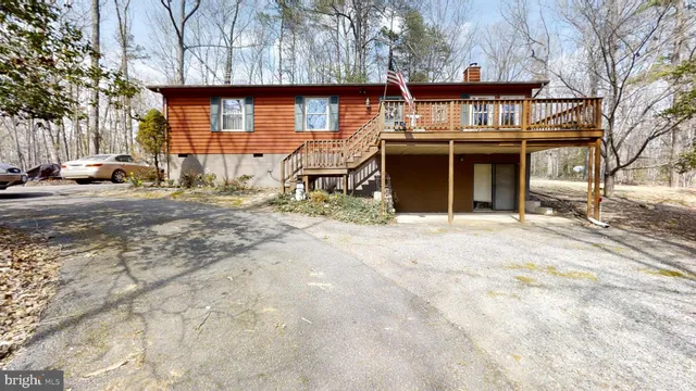 a view of a house with large trees
