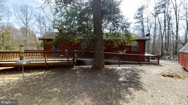 a balcony with wooden floor and outdoor seating